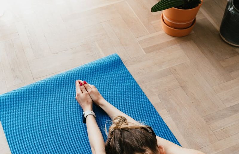 A serene and spacious room with a yoga mat, ready for practice.